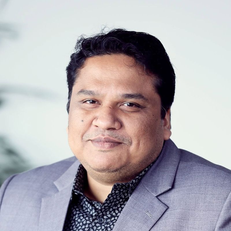Kazi Mohiuddin in a grey blazer